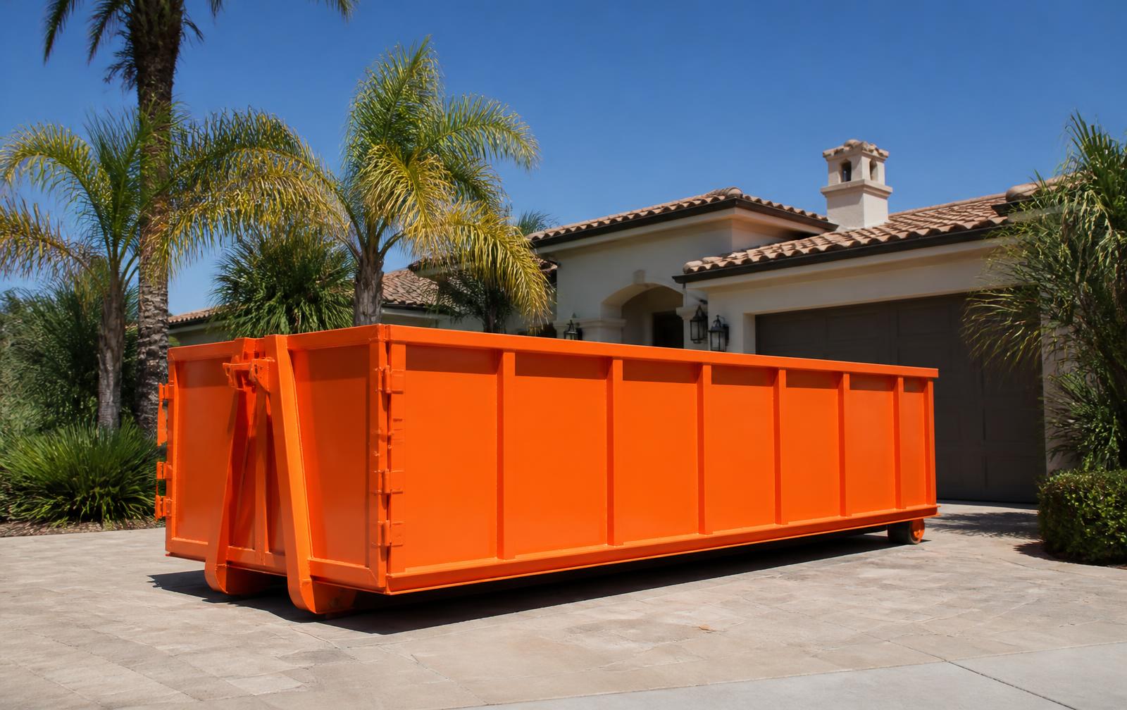 Orange roll-off dumpster delivered to a residential driveway in Orange County, California